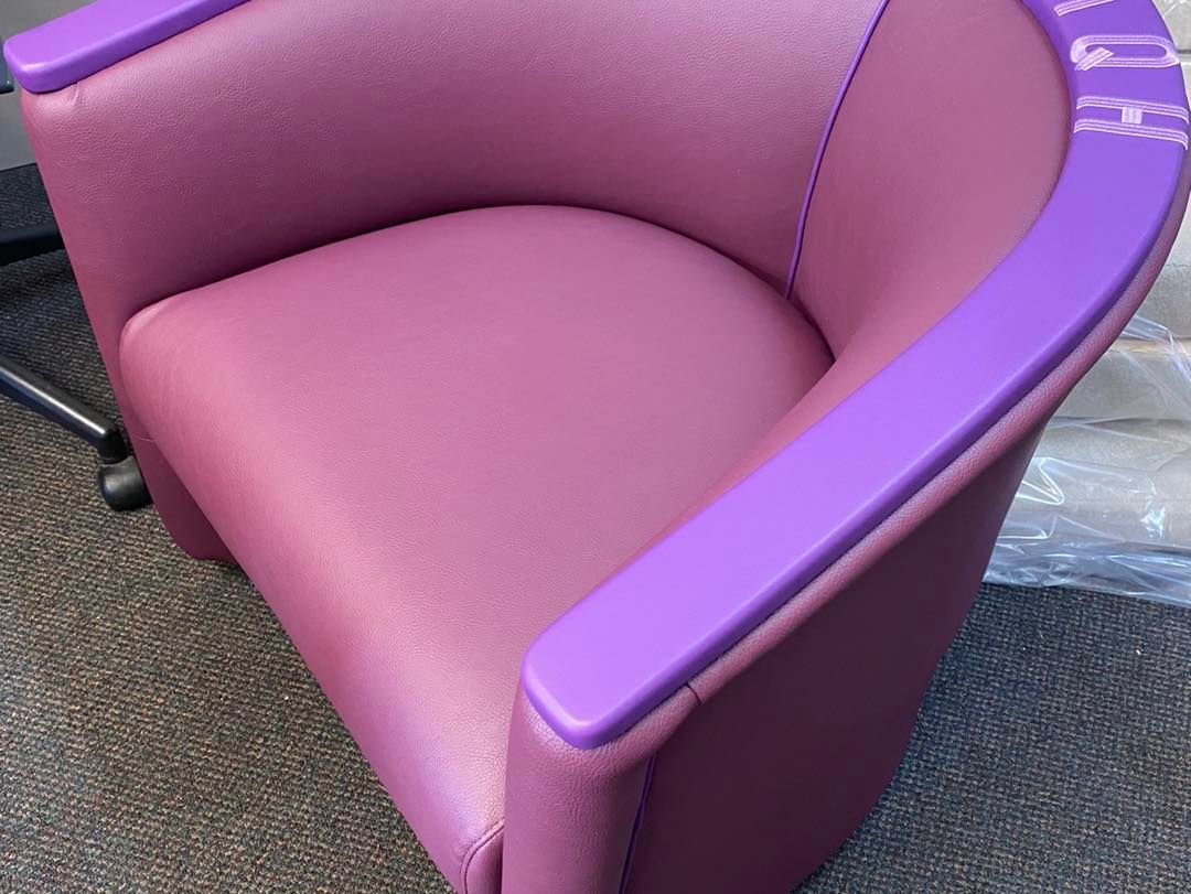 A Pink Chair With Purple Armrests is Sitting on the Floor — Aztak Upholstery In Manunda, QLD