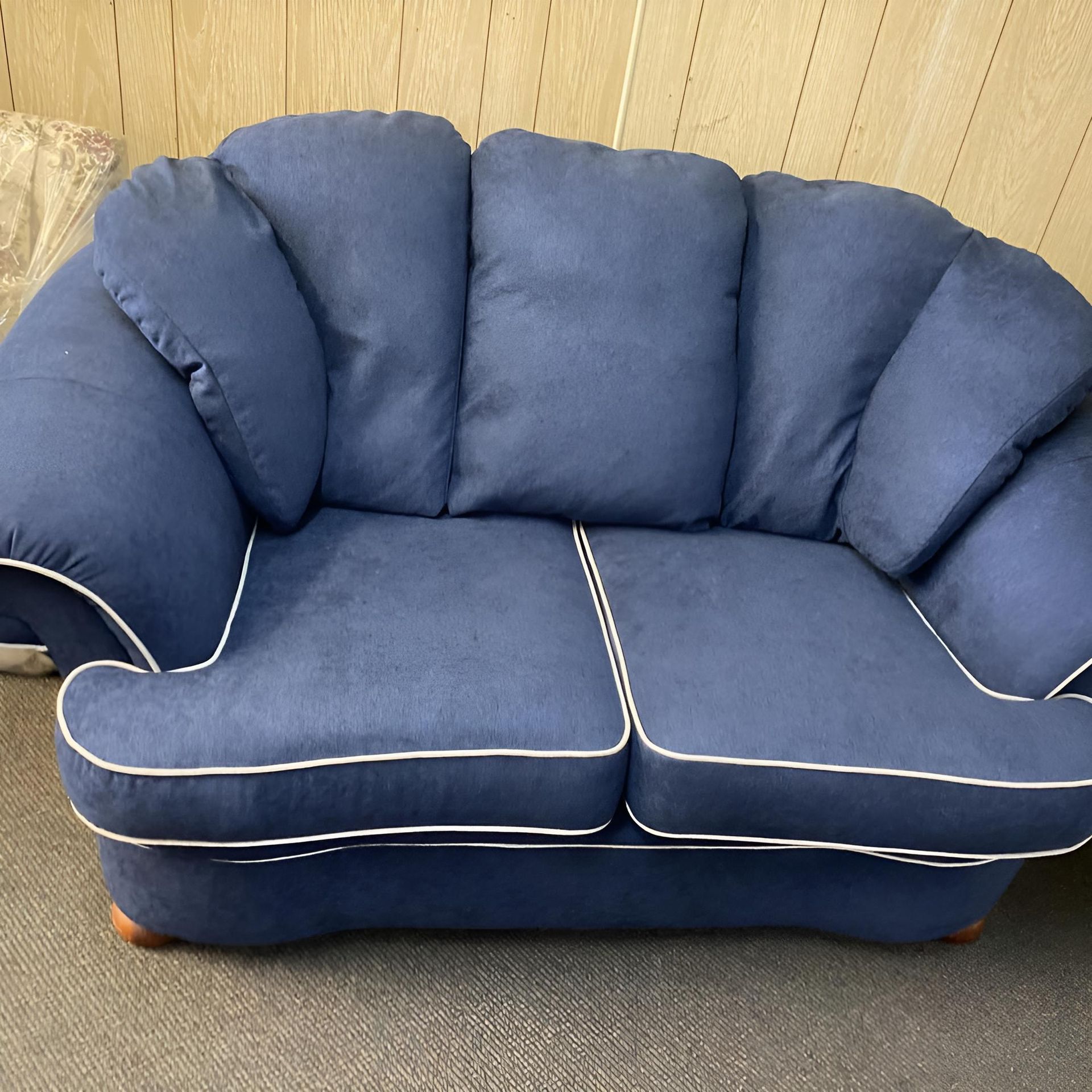 A Blue Couch With White Trim Sits on a Carpeted Floor — Aztak Upholstery In Manunda, QLD