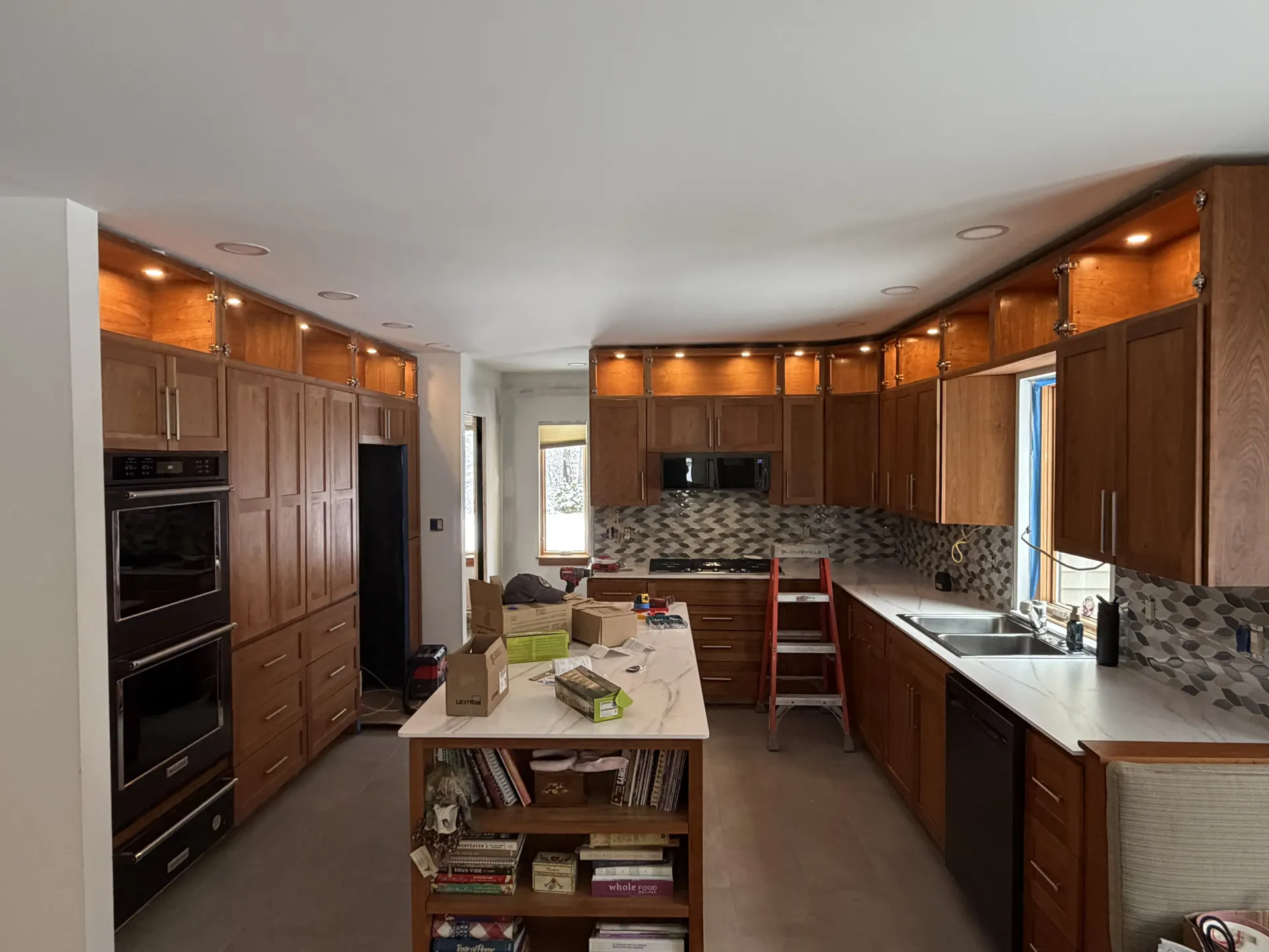Modern kitchen with wooden cabinets, granite countertops, island, and stainless appliances