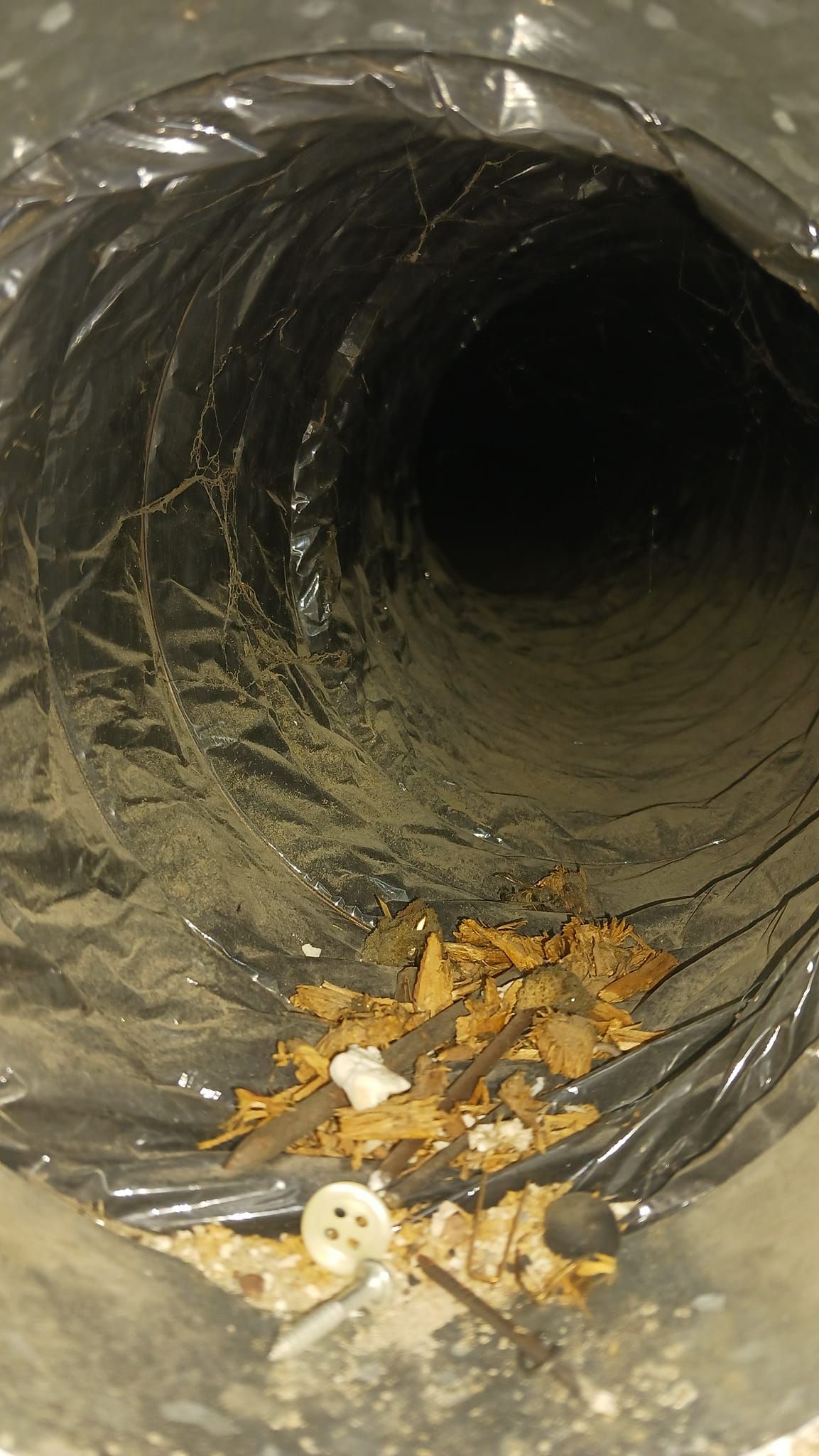 A close up of a dirty air duct with a lot of dust in it.