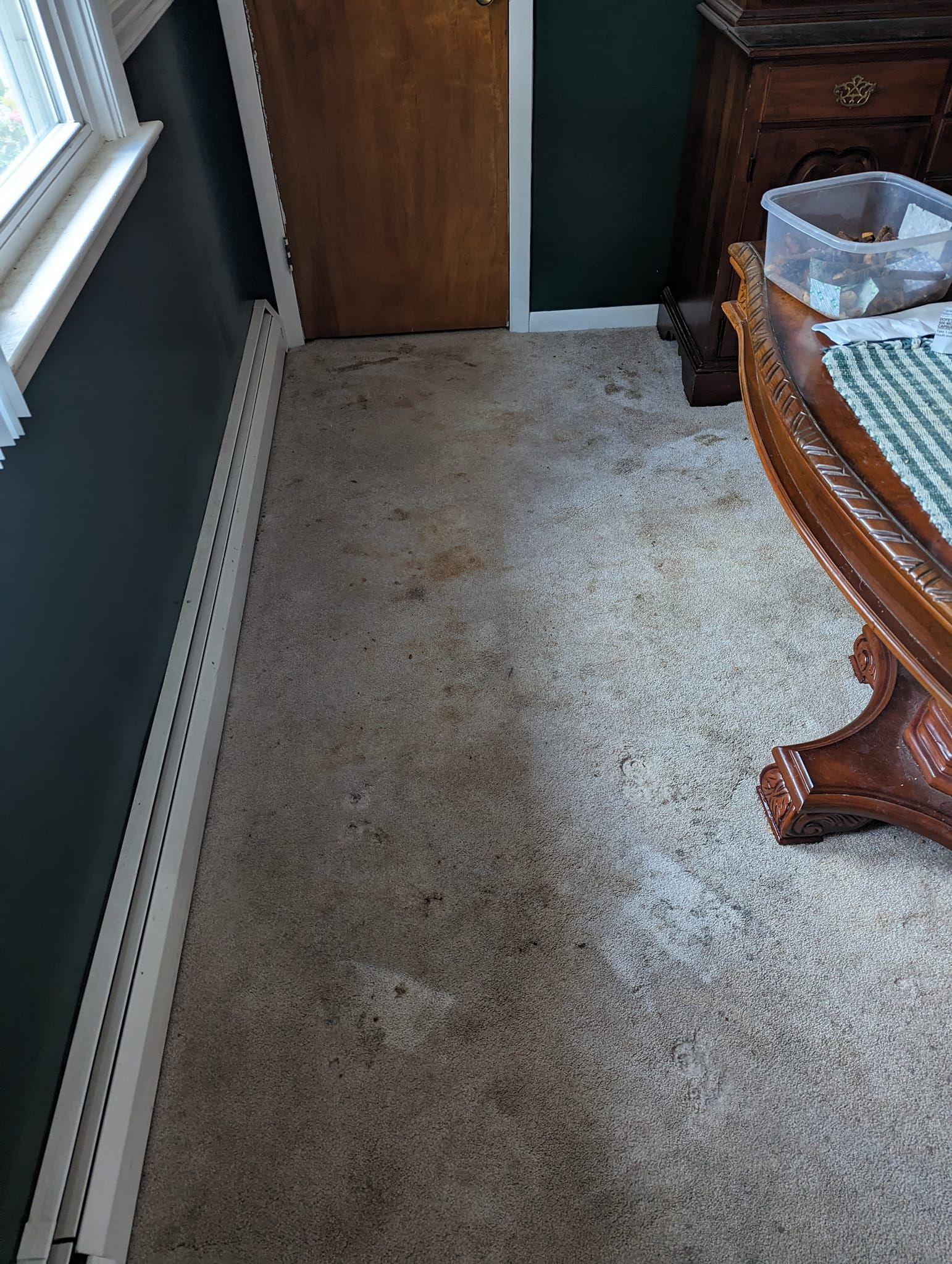 A room with a table and a box on the floor.