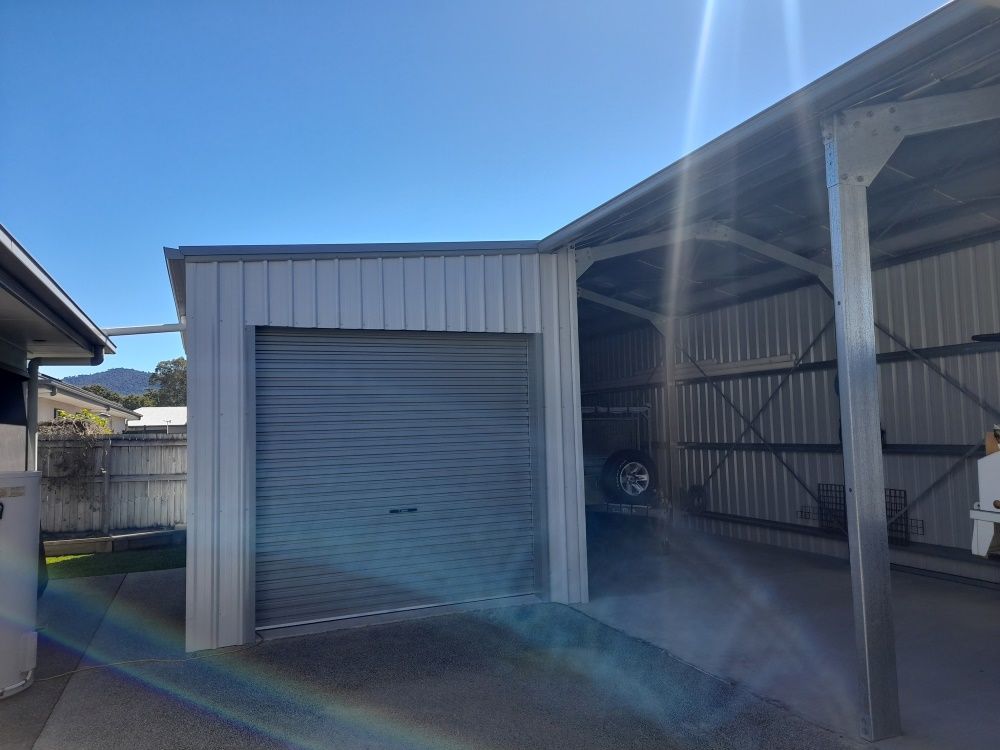 A Car Is Parked In A Garage Under A Canopy — Whit Coast Sheds in Gregory River, QLD