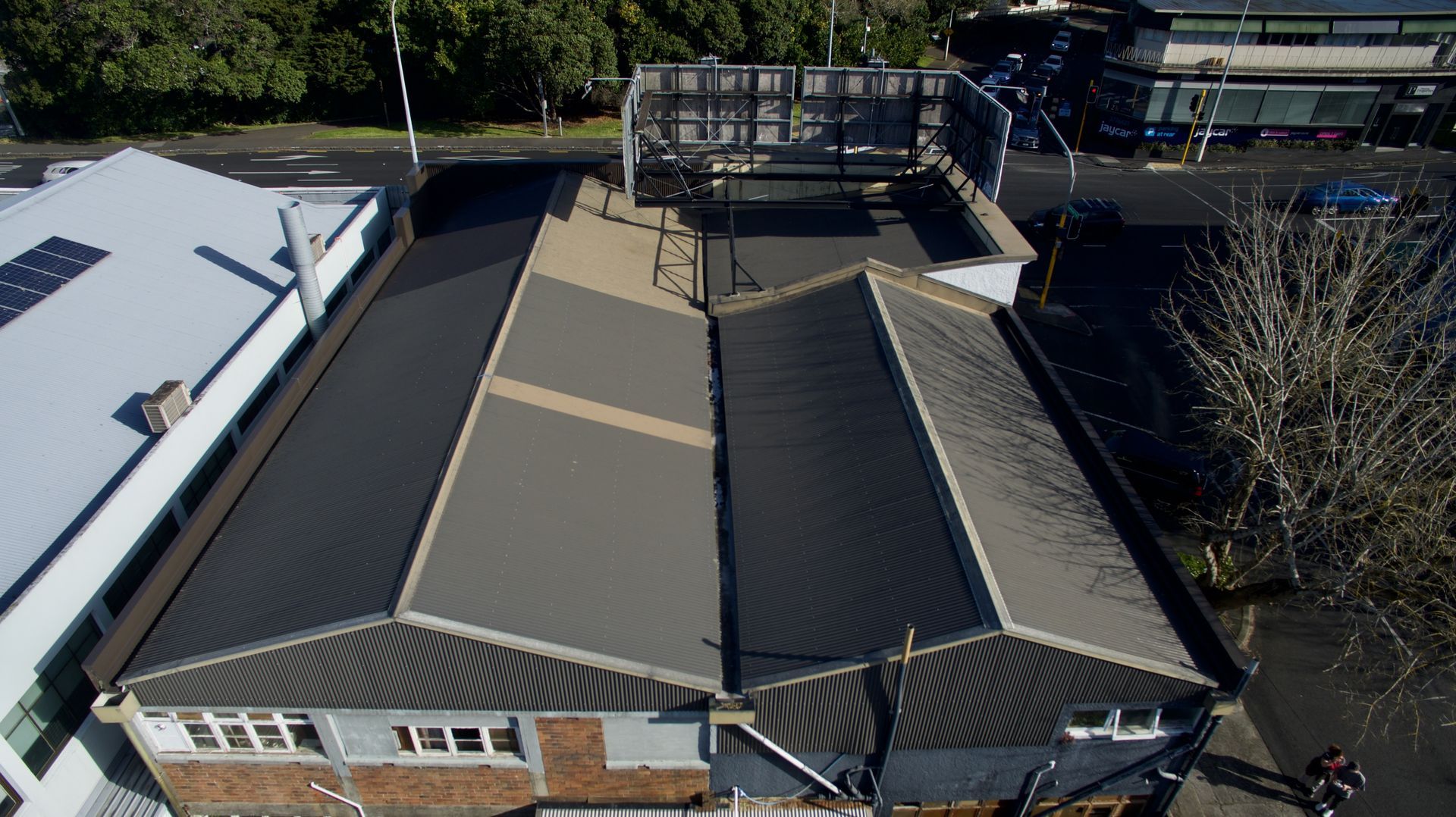 A White House with a Gray Roof and a Blue Sky — Auckland, NZ — Pro Roofing A White House with a Gray Roof and a Blue Sky — Auckland, NZ — Pro Roofing
