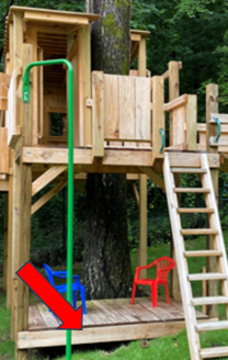 Red arrow pointing to a blue object on a wooden playground platform beneath a treehouse.