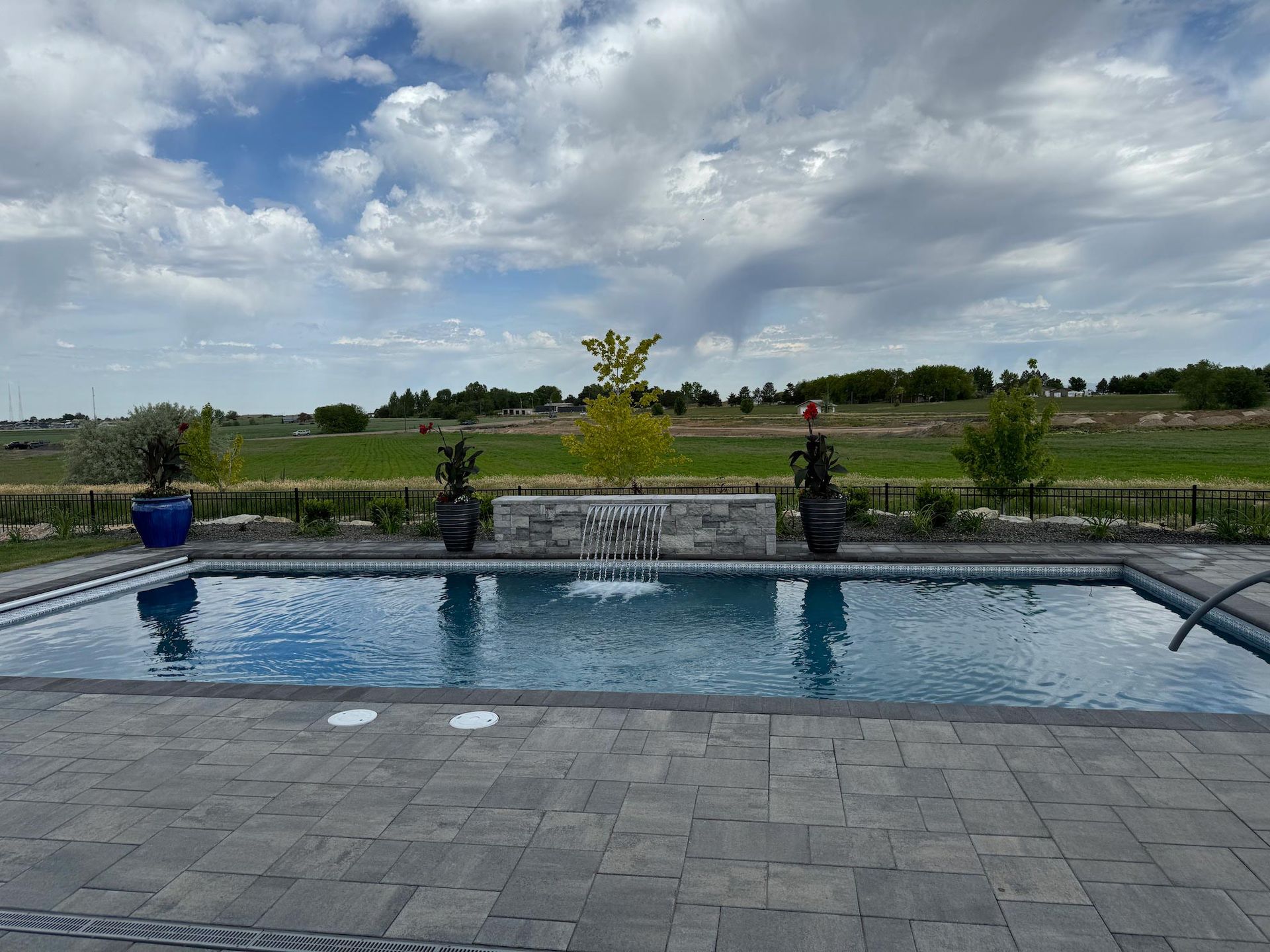 A large swimming pool with a waterfall in the middle of it