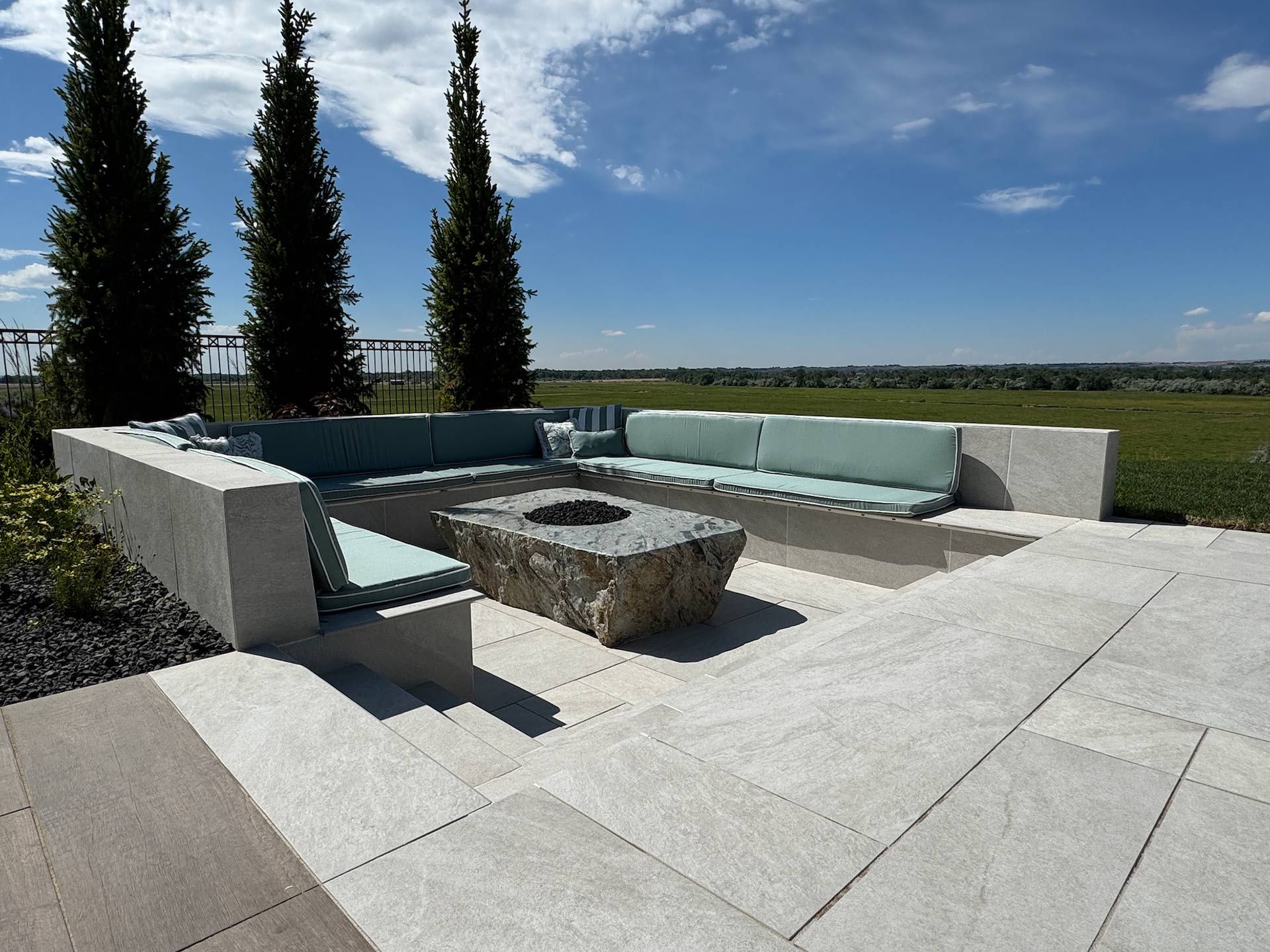 A patio with a fire pit and a couch