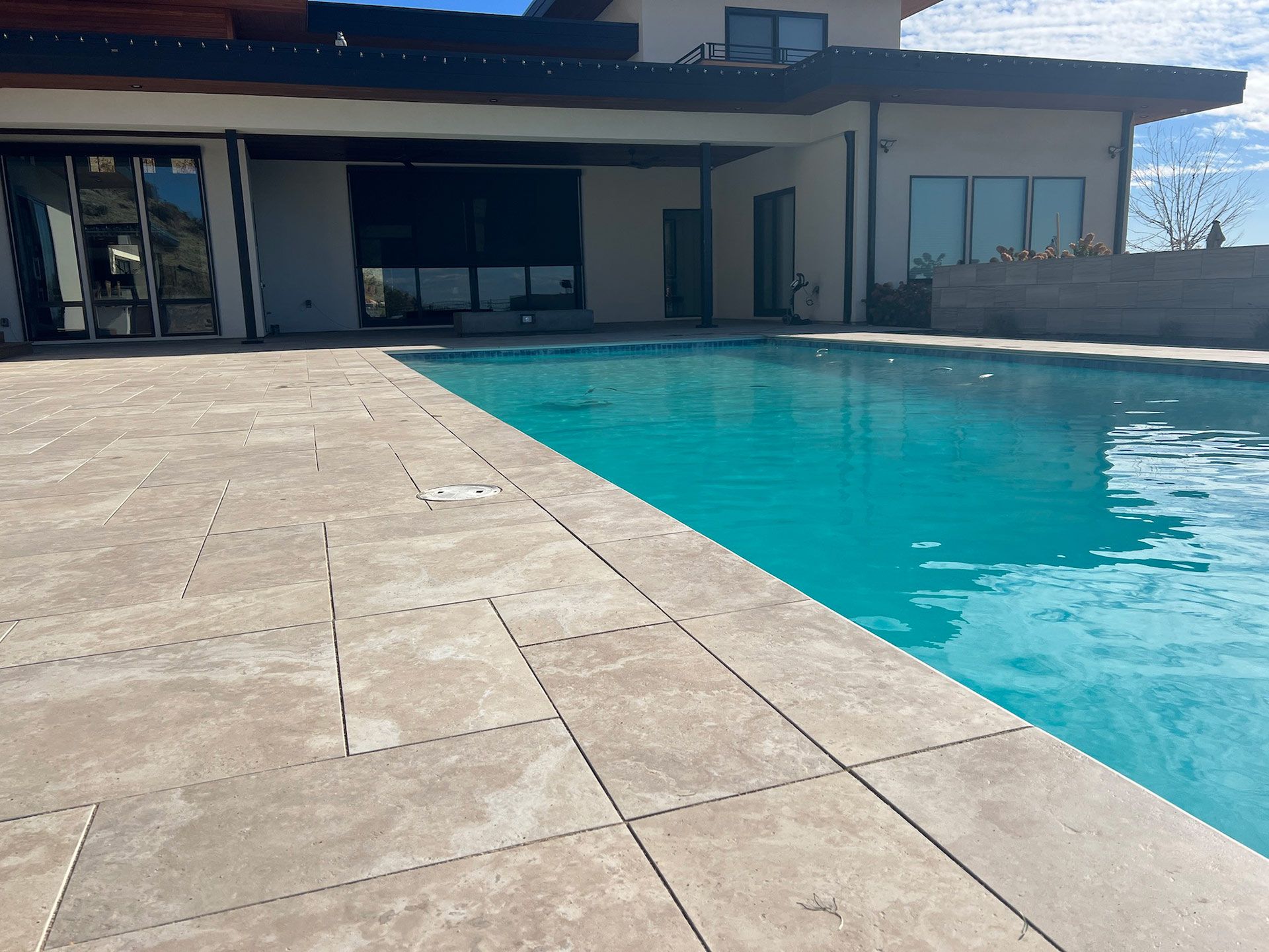 A patio with a table and chairs and a fireplace