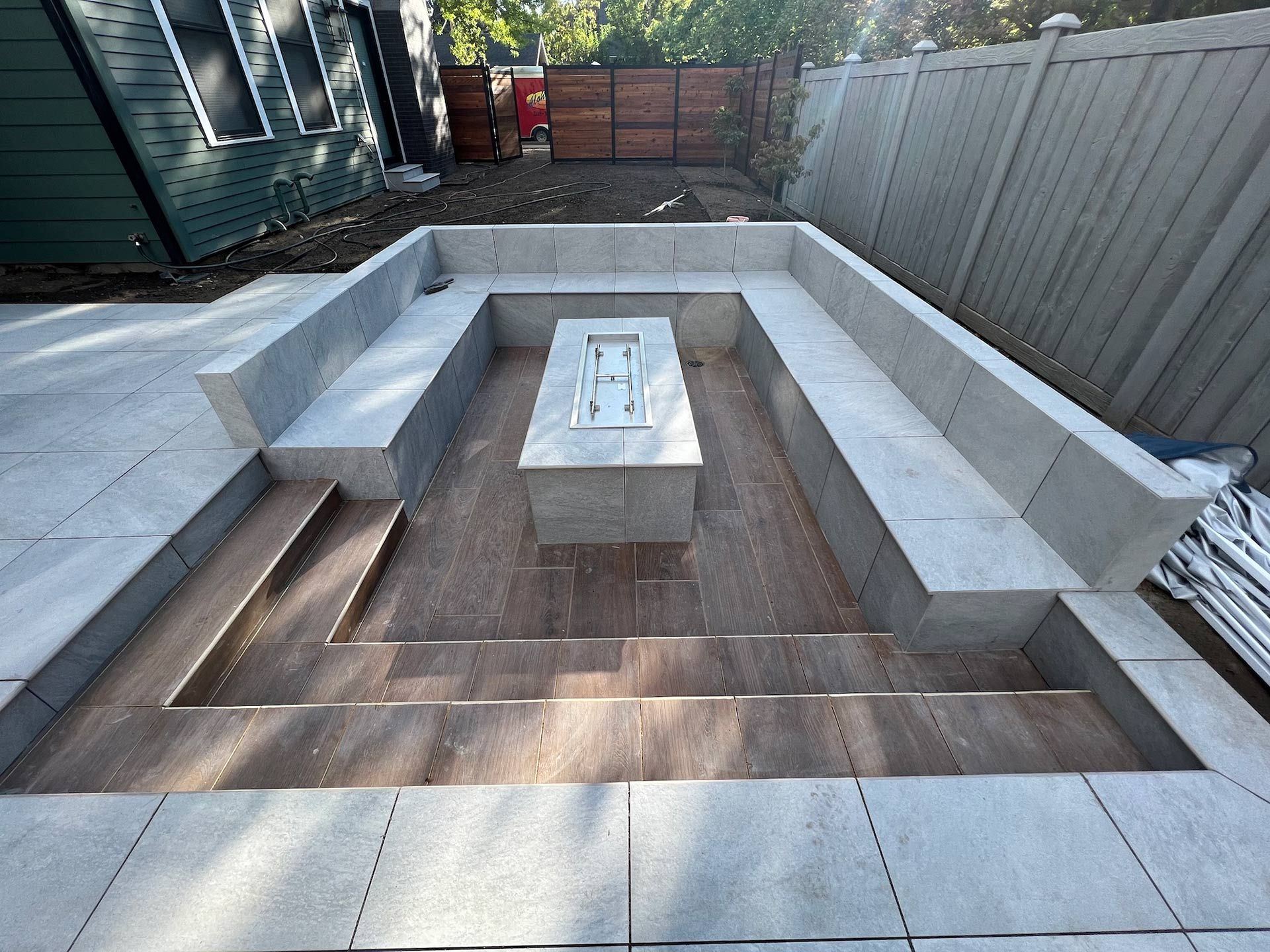 A patio with a fire pit in the middle of it