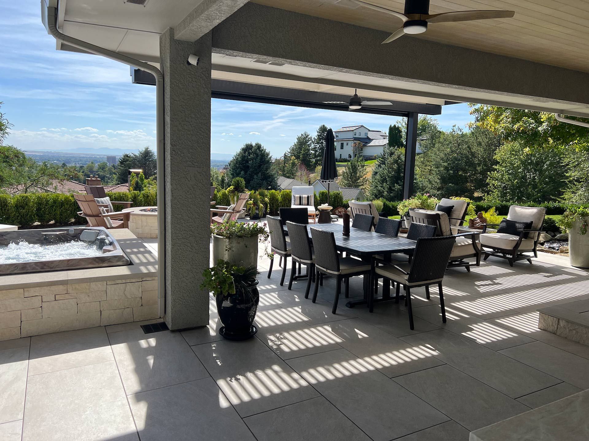 A patio with a table and chairs and a ceiling fan