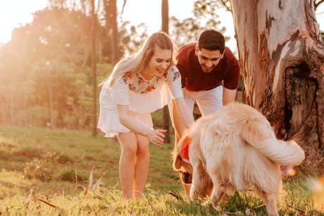 Couple playing with their dog