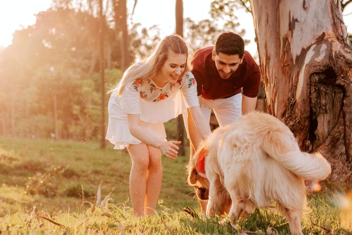 Couple playing their dog