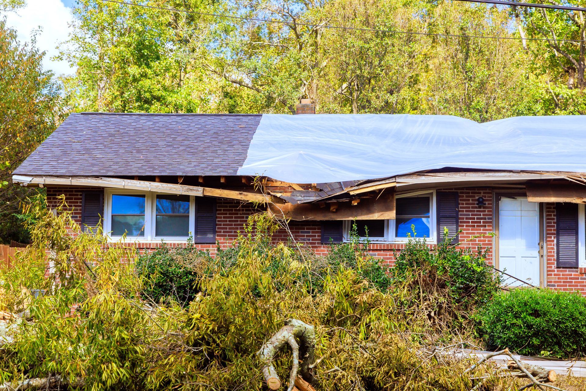 Single-story brick house with solar panels on the roof.