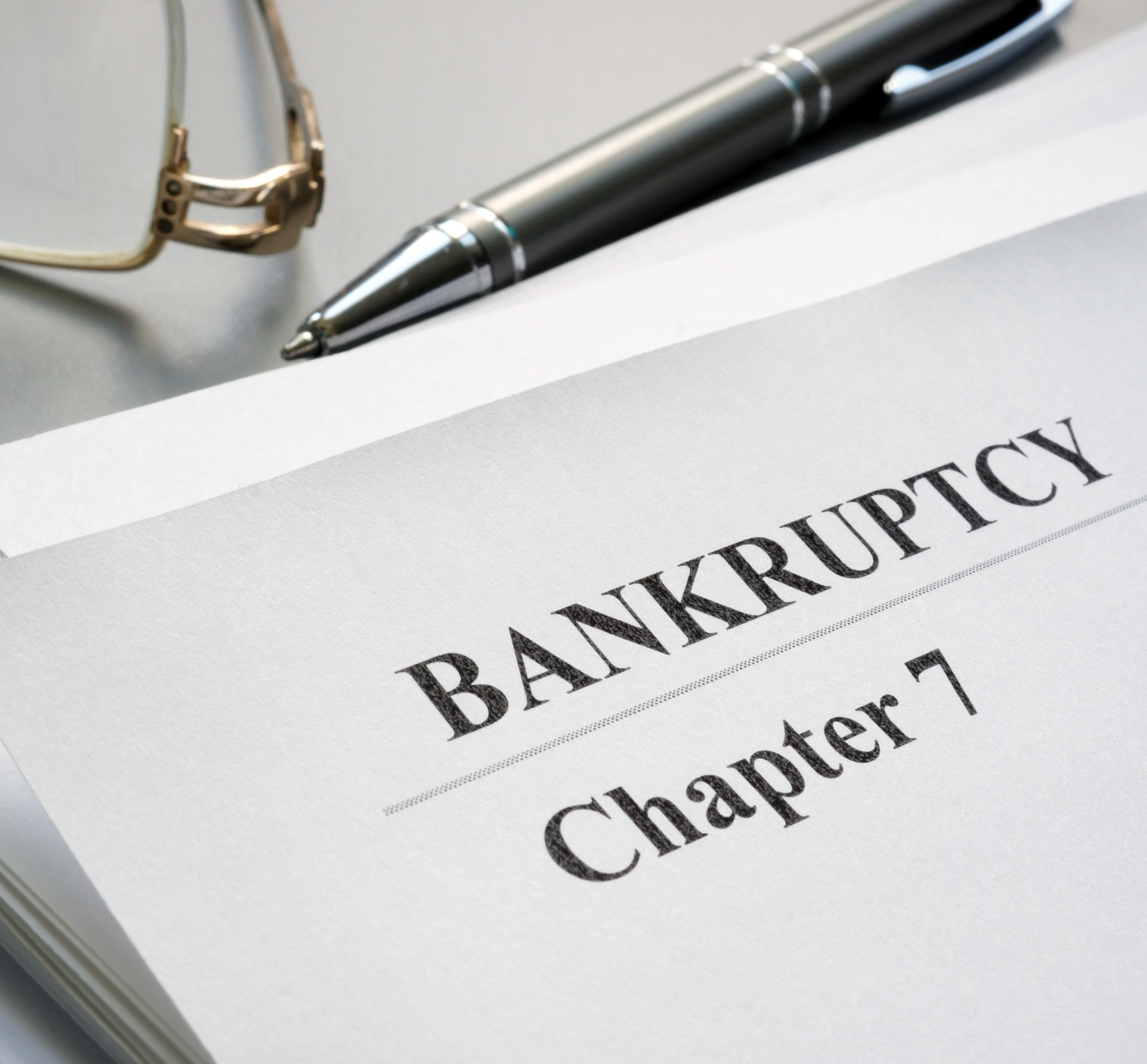 Am I Eligible for Chapter 7 Bankruptcy in Ohio — Susan Lax Law Office Bankruptcy Chapter 7 document with pen and eyeglasses on a desk