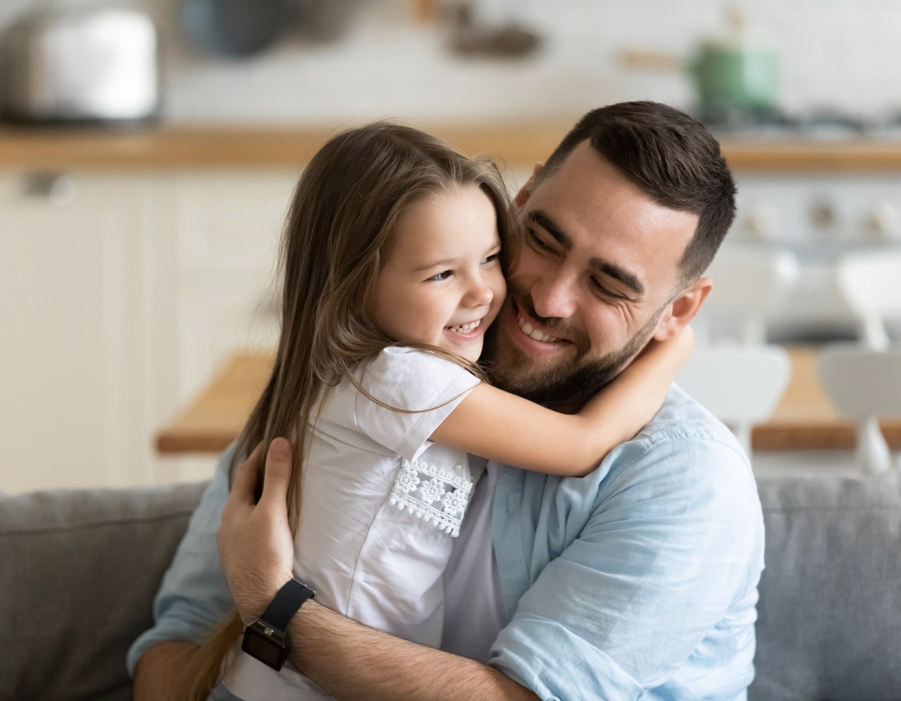 Father Hugging Daughter At Home
