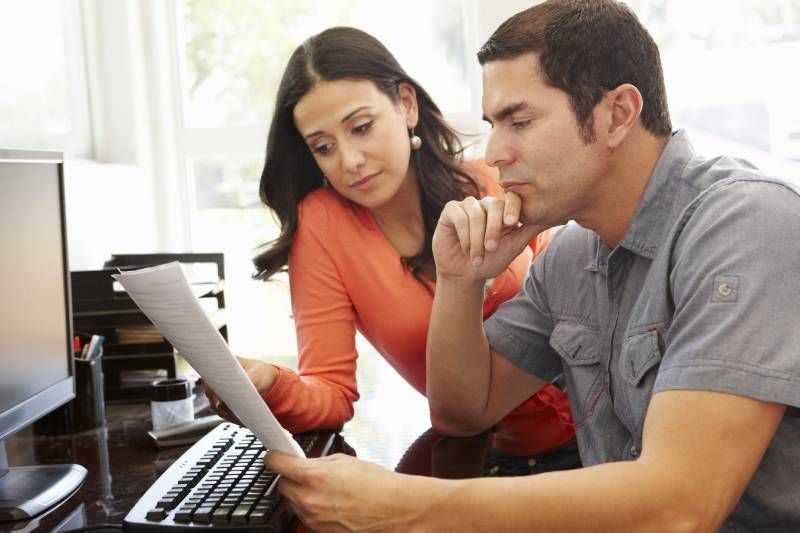 Cash In Envelope Written Alimony — Fairlawn, OH — Susan Lax Law Office Couple Reviewing Legal Documents