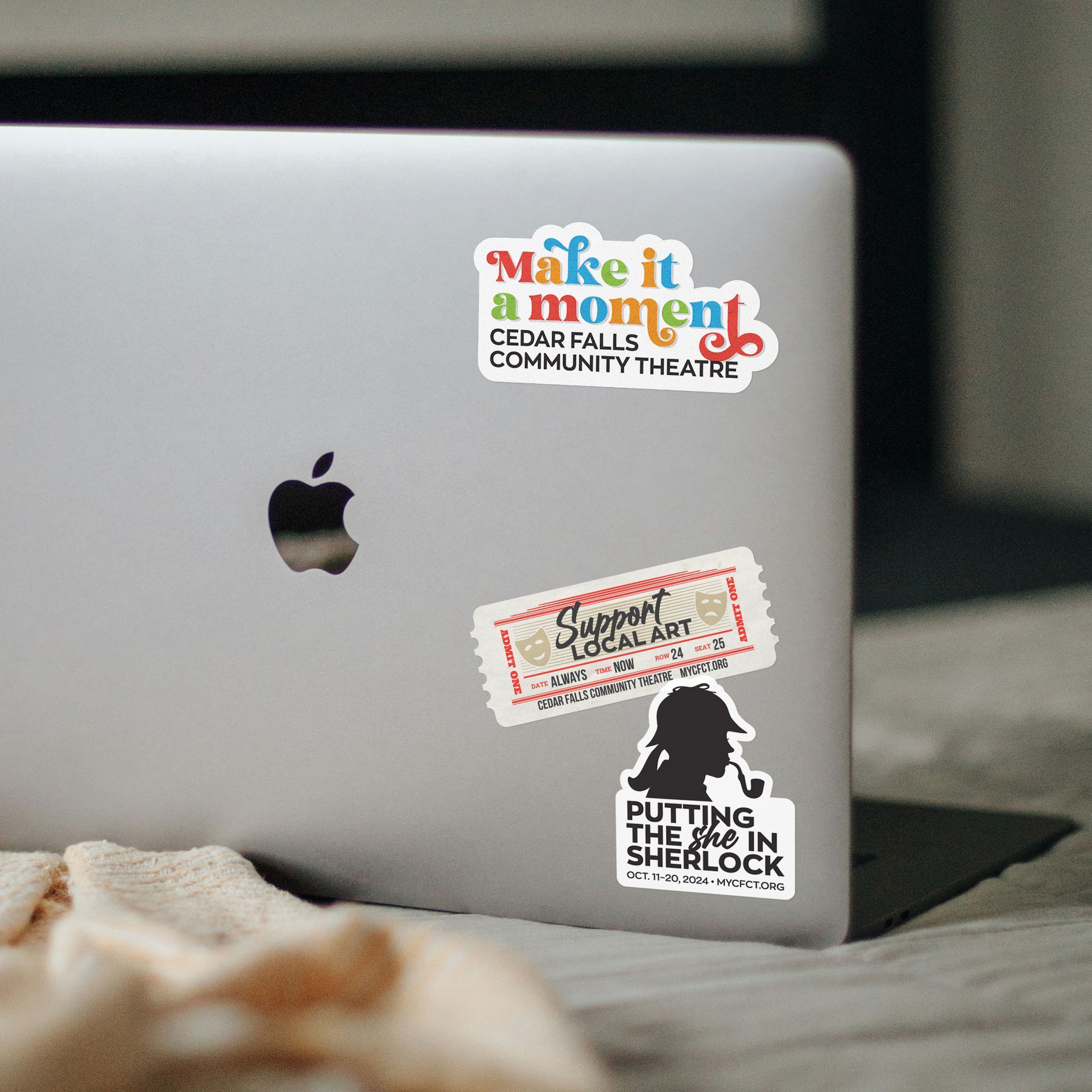 A laptop with stickers on it that say make it a moment