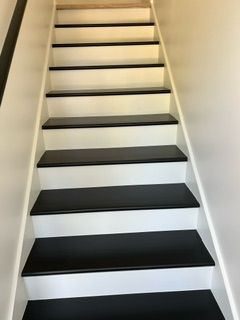 Dining room with wood table and chairs, blue walls, hardwood floor, and a fireplace.