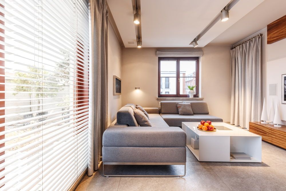 A Living Room with A Couch, Coffee Table, and Blinds — Turbo Clean in Hallidays Point, NSW