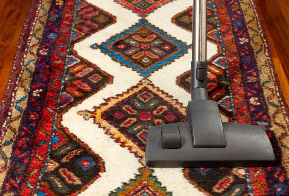 A Rug Is Being Cleaned with A Vacuum Cleaner — Turbo Clean in Taree, NSW