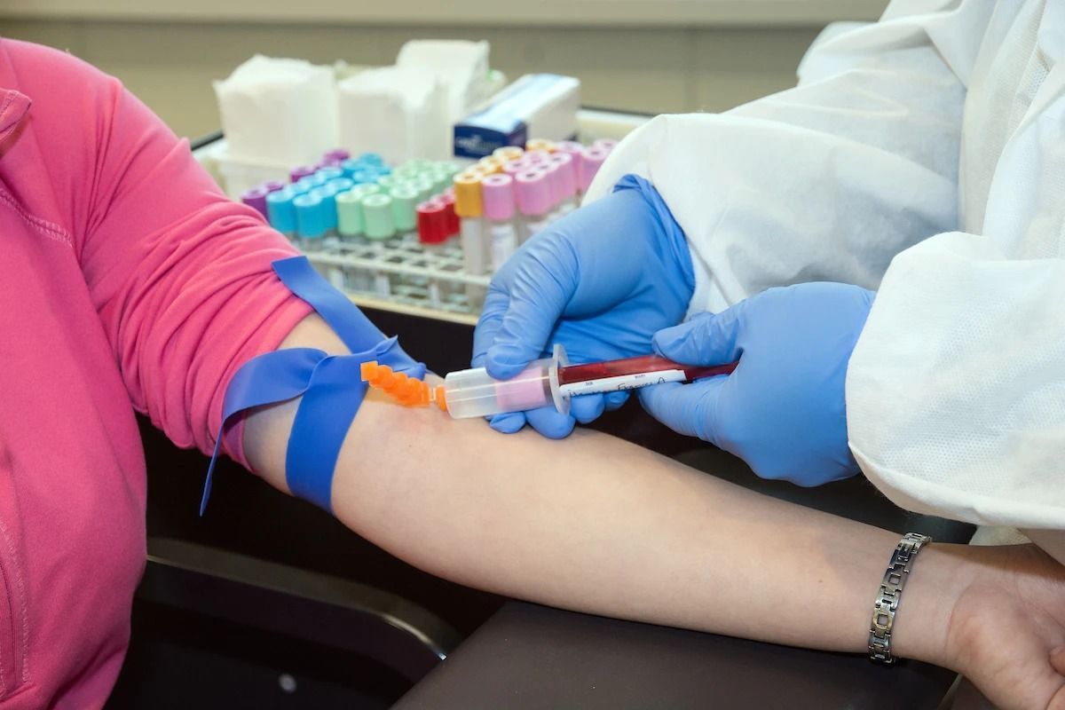 Certified phlebotomist preparing blood draw tray