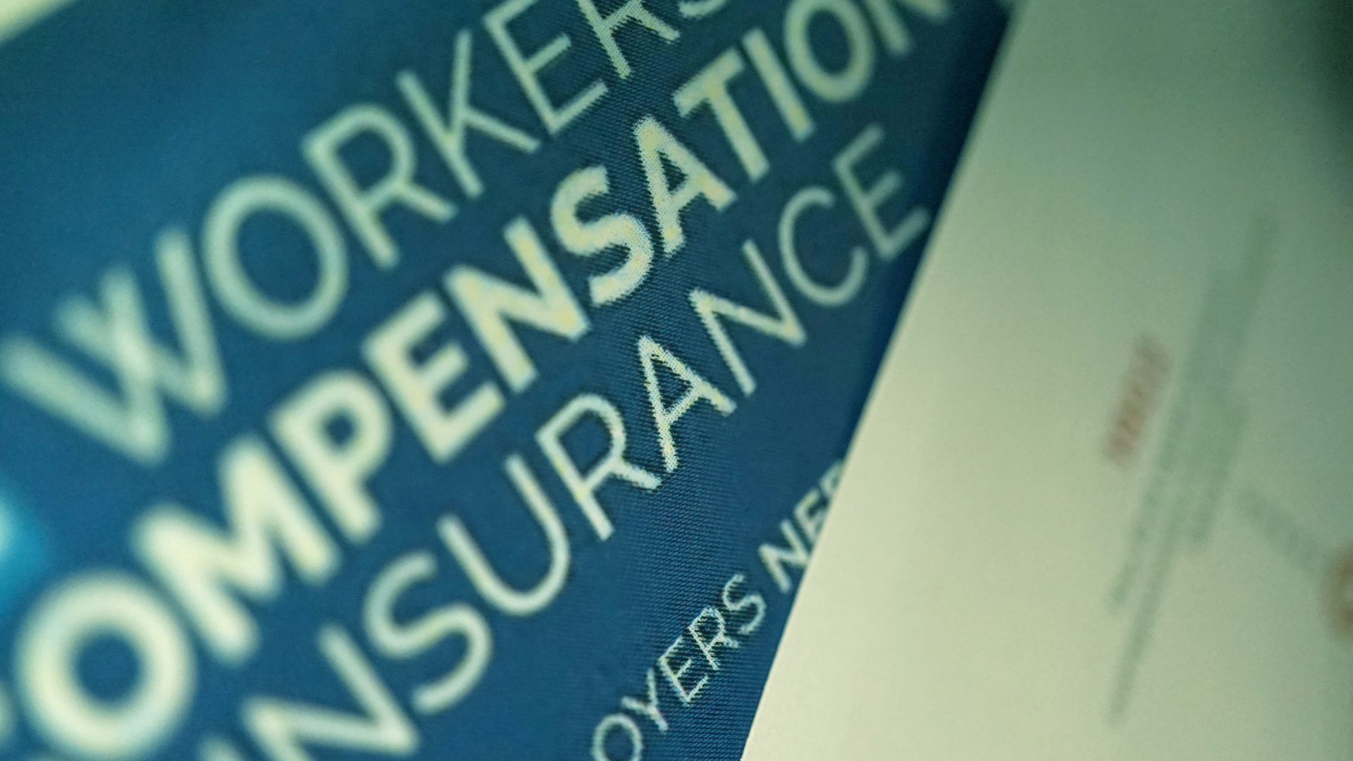 A blue sign that says workers compensation insurance on it