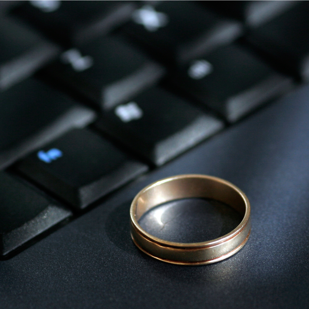 A gold ring sits on top of a black keyboard
