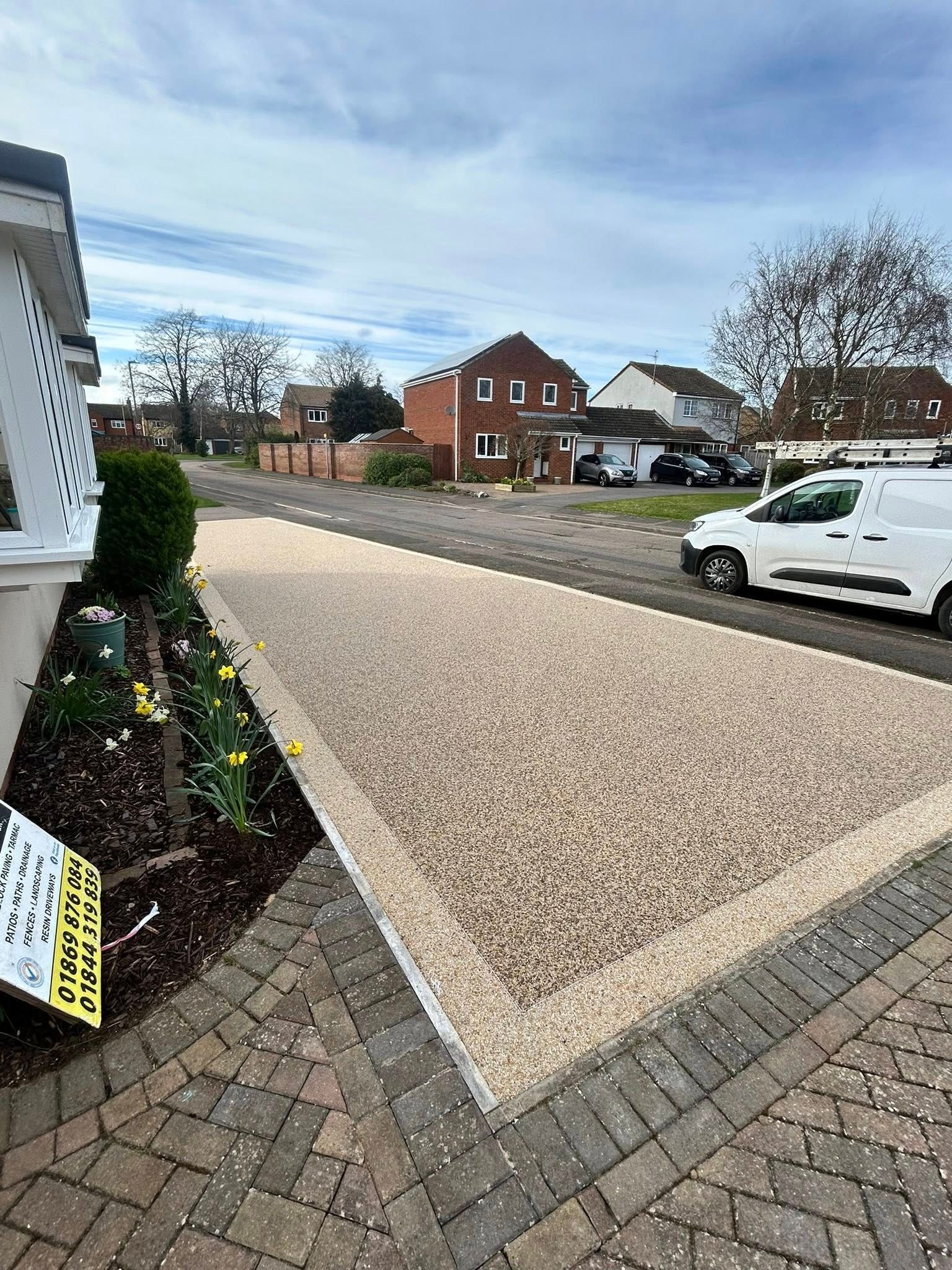 Modern two-story house with a tiled driveway and landscaped front yard