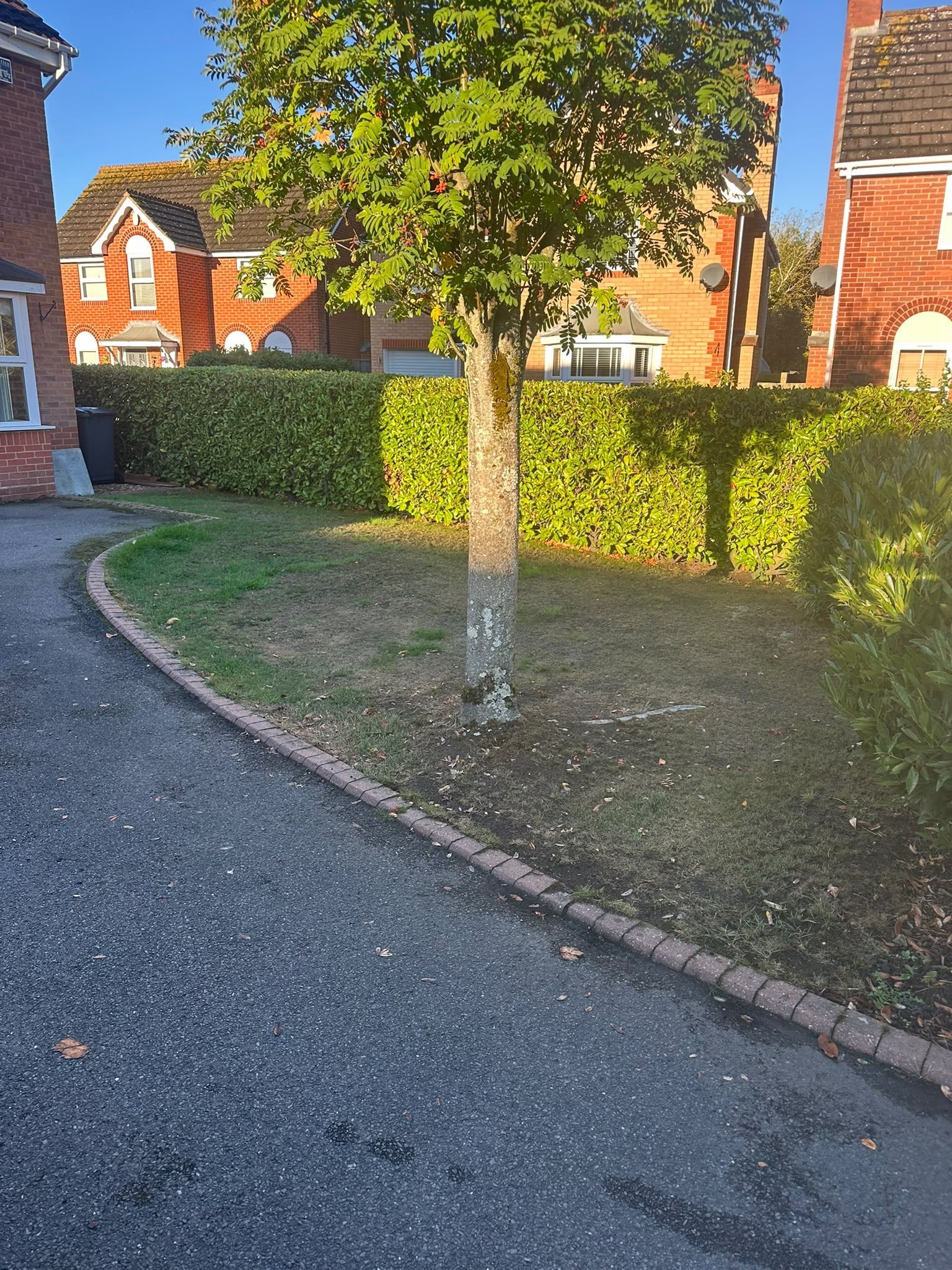 Front garden driveway entrance with a kerb crossing and landscaped border in Oxfordshire