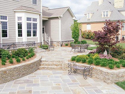 Modern two-story house with a tiled driveway and landscaped front yard