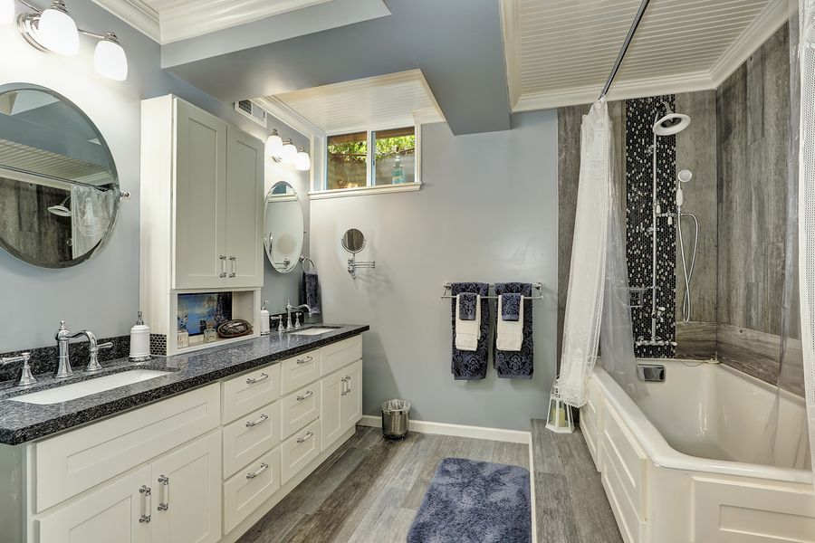 A bathroom with two sinks and a bathtub