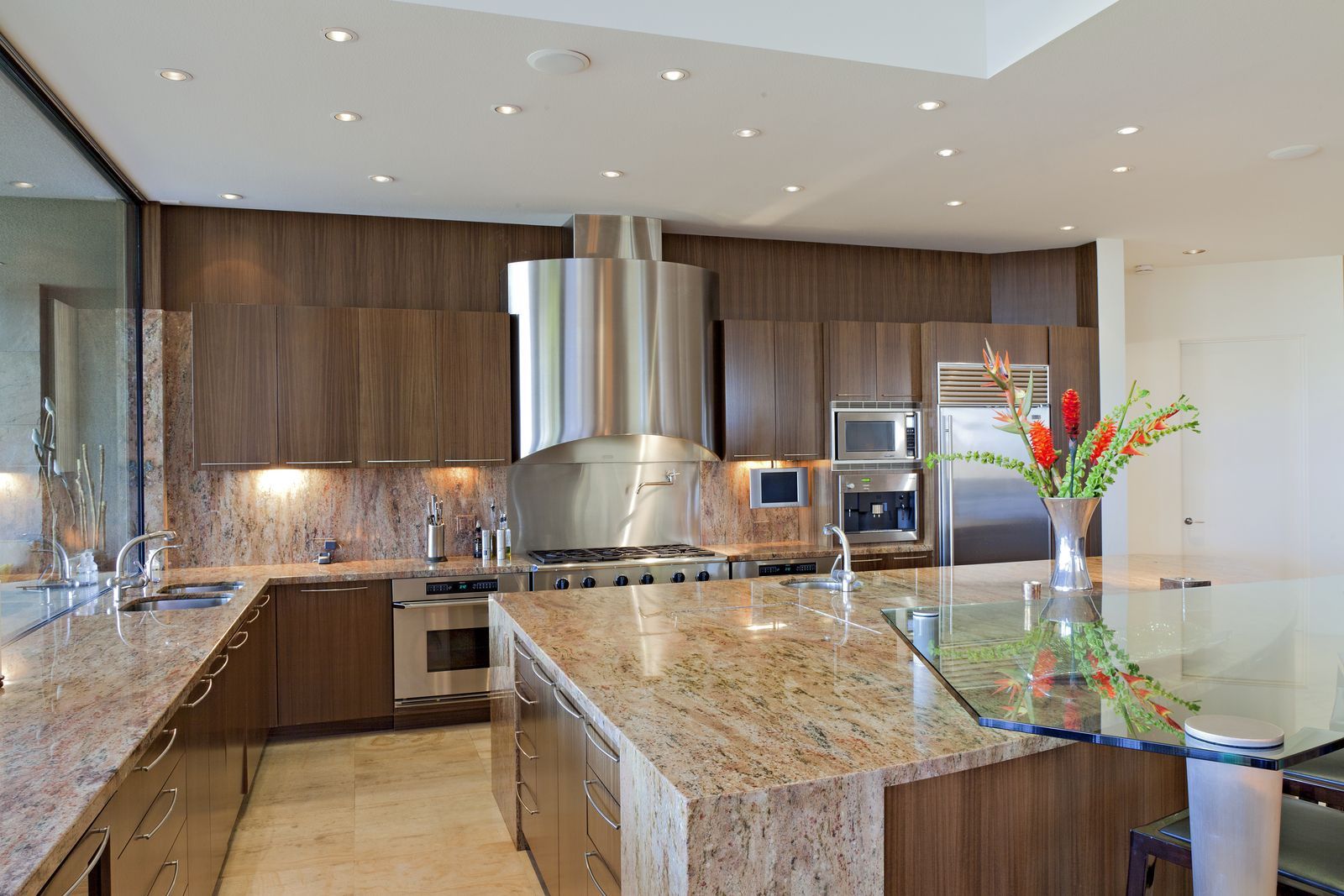 A kitchen with granite counter tops and stainless steel appliances