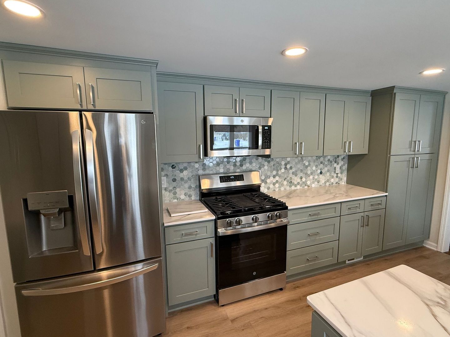 A kitchen with a vase of flowers on the counter