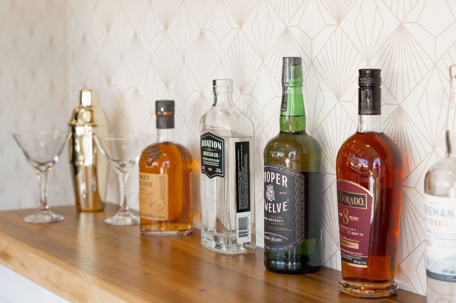 A line-up of spirits on a shelve in The Cocktail Cart