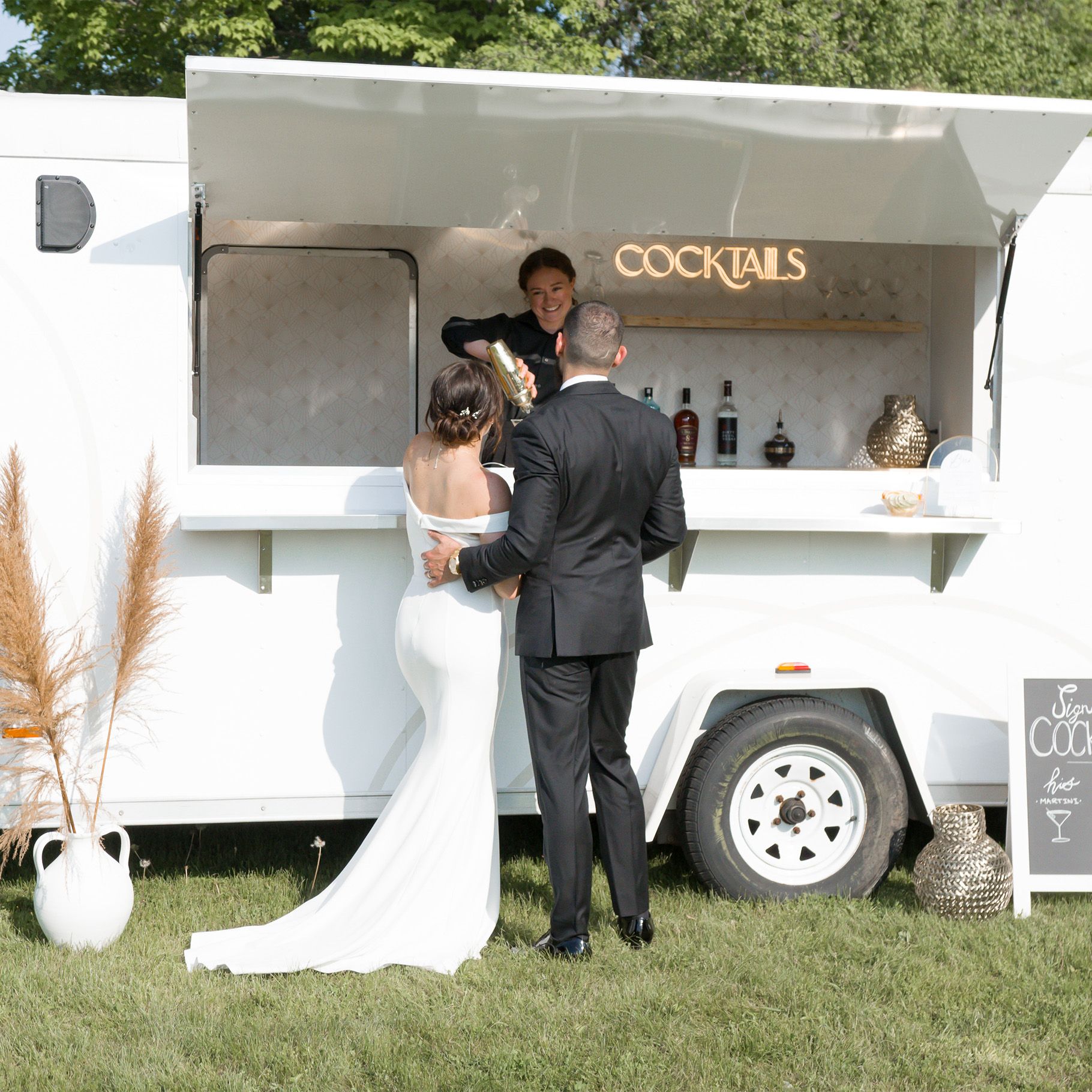 Couple getting drinks at The Cocktail Cart