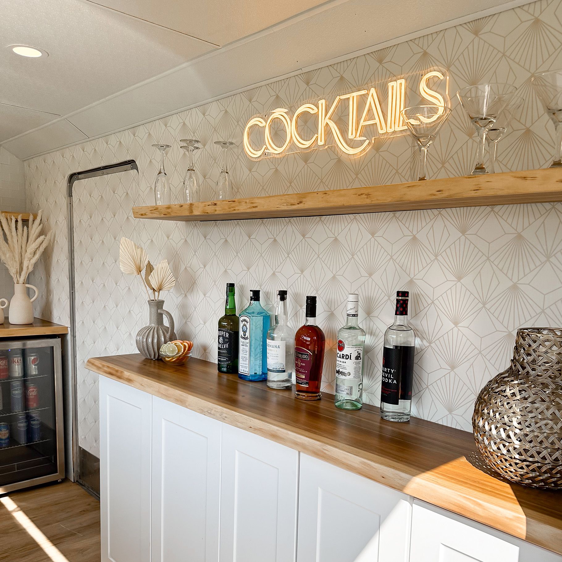 Inside The Cocktail Cart bar with a lineup of spirits