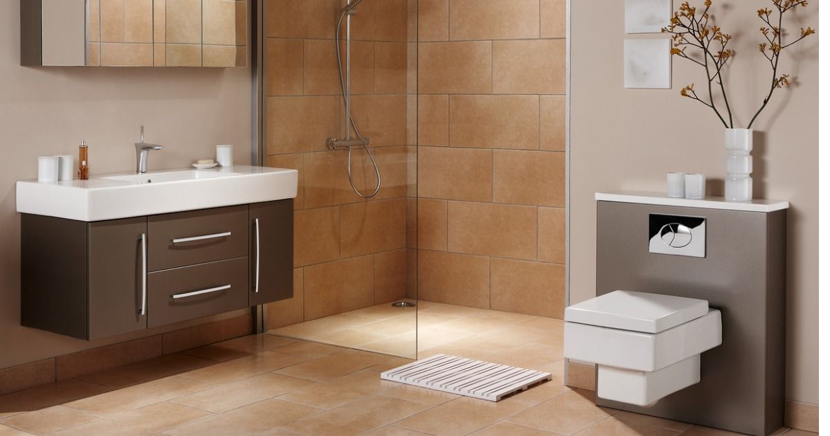 A bathroom with a sink , toilet and walk in shower.