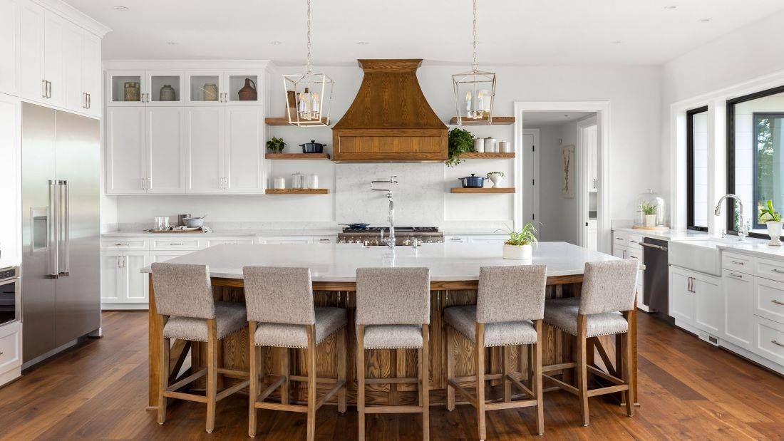 A kitchen with a large island and stools