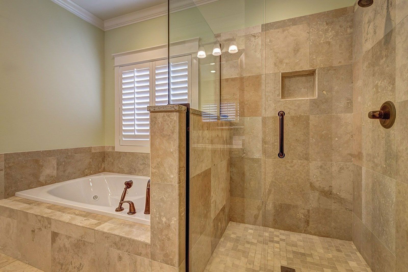 A bathroom with a walk in shower and a bathtub.