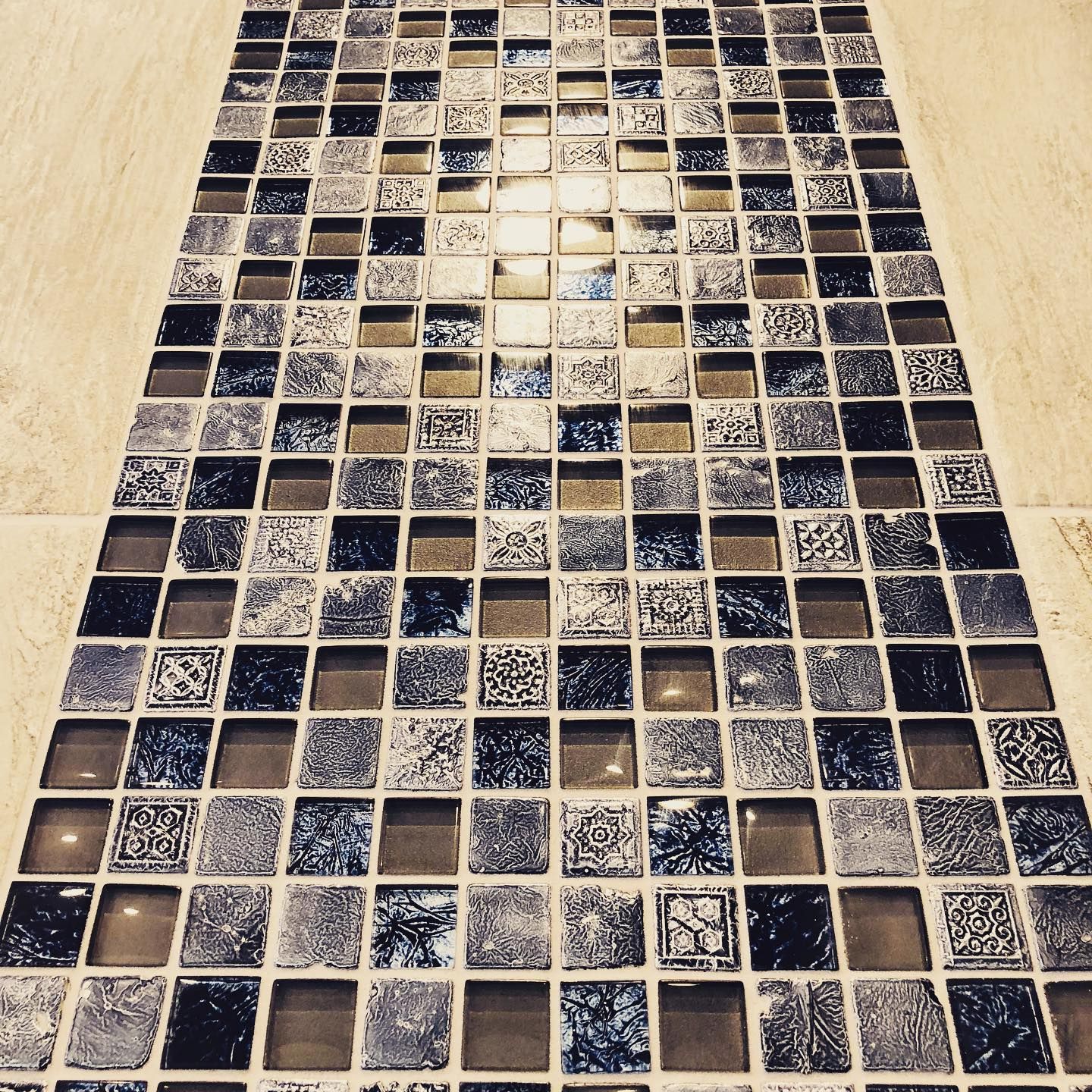 A row of square tiles on a white floor