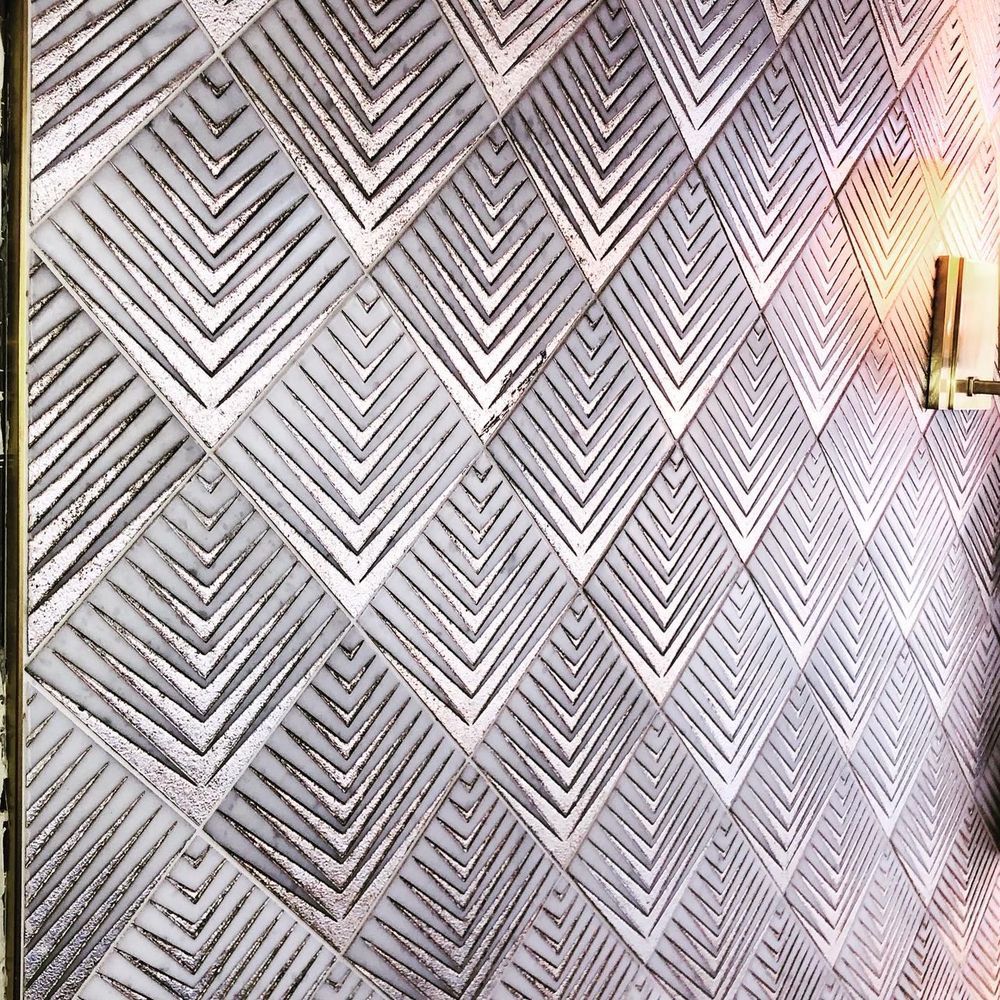 A close up of a wall with a geometric pattern on it.