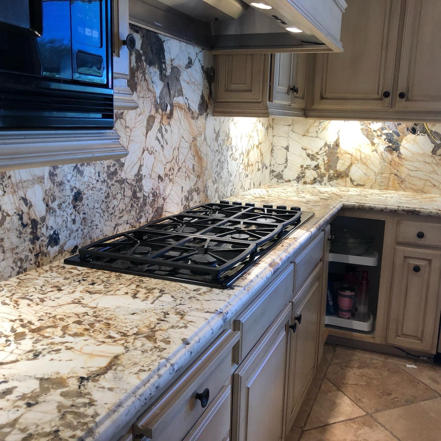 A kitchen with granite counter tops and a stove top oven