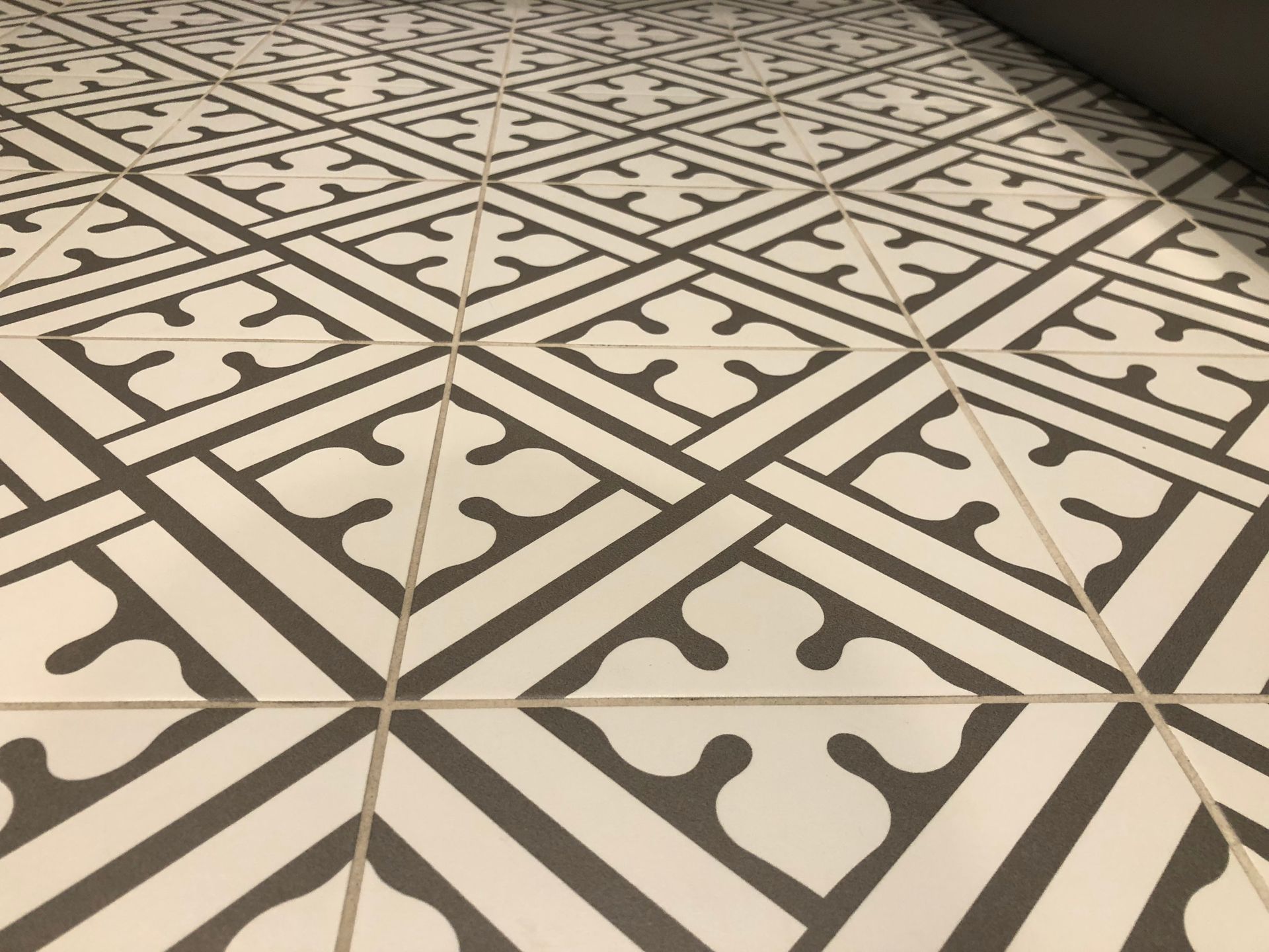 A black and white tile floor with a geometric pattern