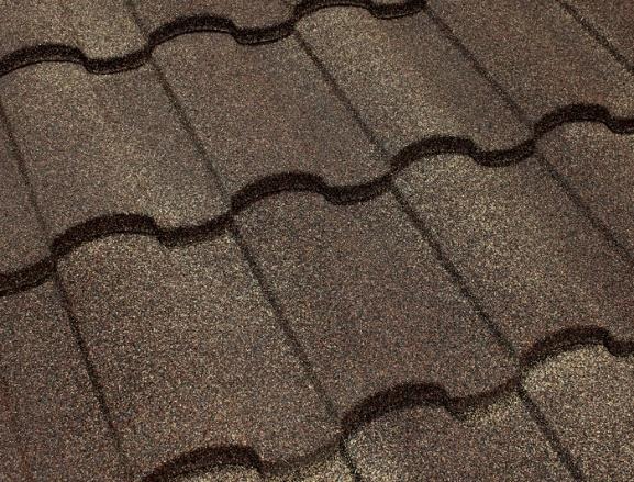 Close-up of brown asphalt roof shingles with a wavy pattern and dark seams