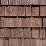 Brown wooden shingle roof tiles in a close-up pattern