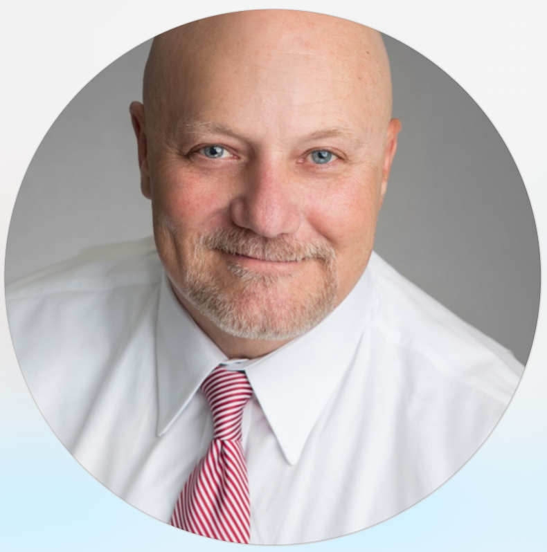 A bald man wearing a white shirt and red and white striped tie