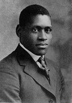 A black and white photo of a man in a suit and tie.