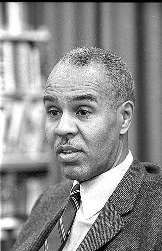 A black and white photo of a man in a suit and tie.