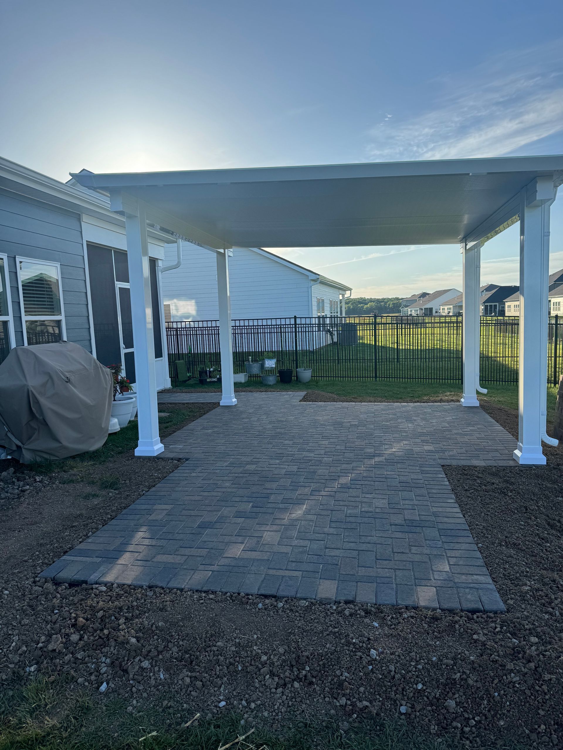There is a carport in front of a mobile home.
