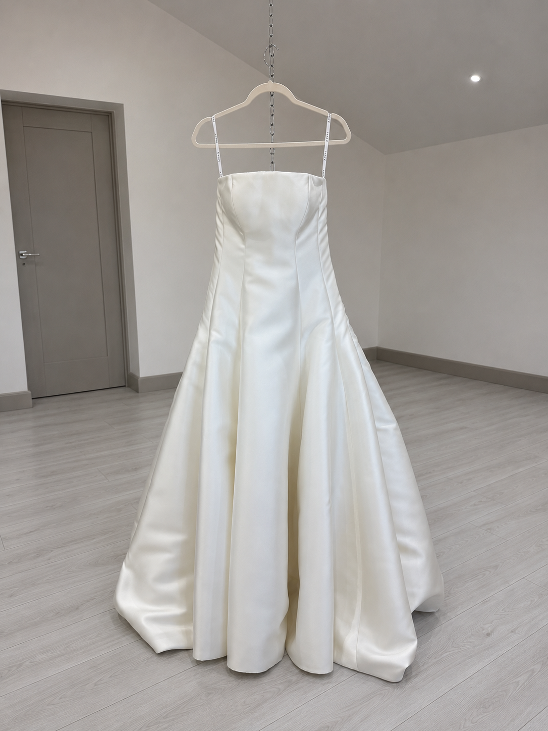 Wedding dress front view after a ballroom bustle, train hidden under the skirt