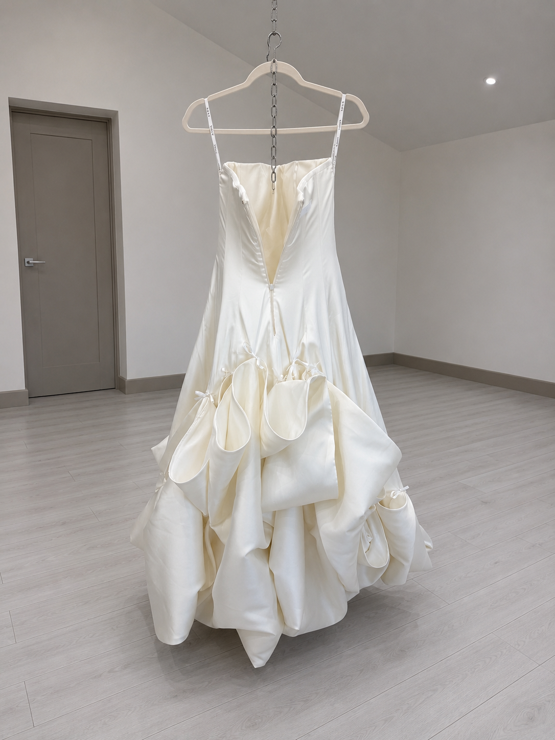 Ribbons sewn into the interior seams of a wedding dress for a ballroom bustle
